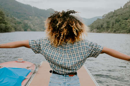 girl at the pier enjoying with arms upの写真素材
