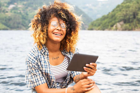 portrait of young woman with the tablet in summerの写真素材