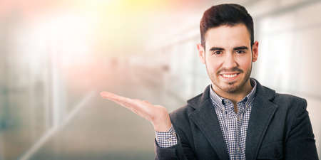 businessman smiling showing the space for advertising and textの写真素材