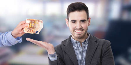 man pointing out the payment in cashの写真素材