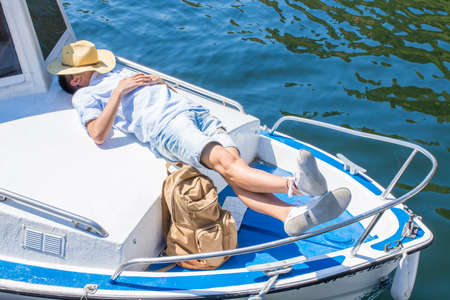 man resting or sleeping on the yacht, summer vacationの写真素材