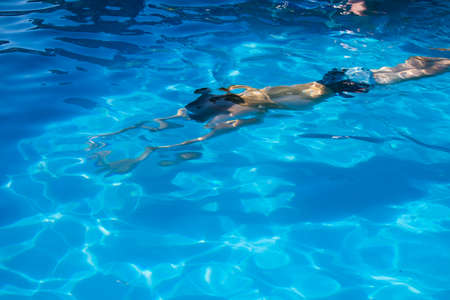 child in the pool in summerの写真素材