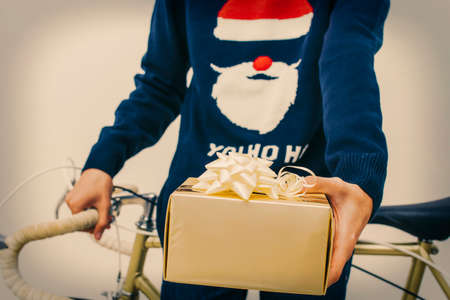young with christmas gift and vintage bike