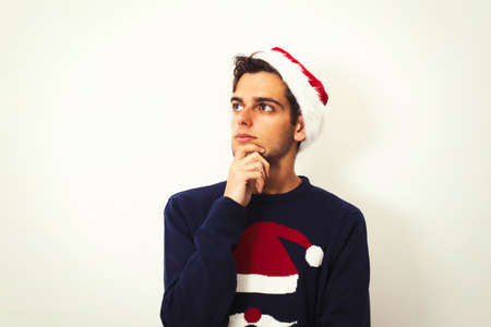 young man with clothes and christmas gift isolated in whiteの写真素材