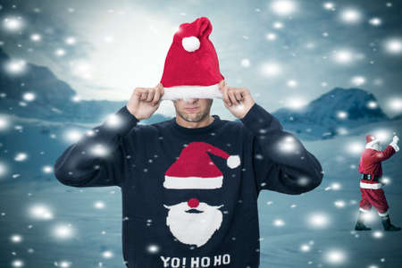 young man tucked away with the christmas hat, santa claus