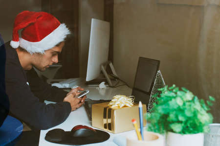 young at home or at the office working or studying at christmasの写真素材