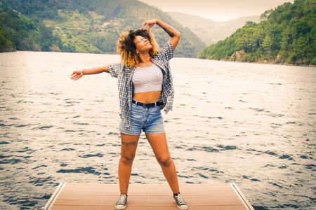 happy girl enjoying outdoor, landscape with waterの写真素材