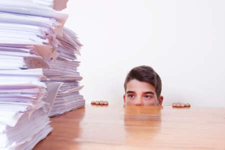 child student on the desk with stacked papers