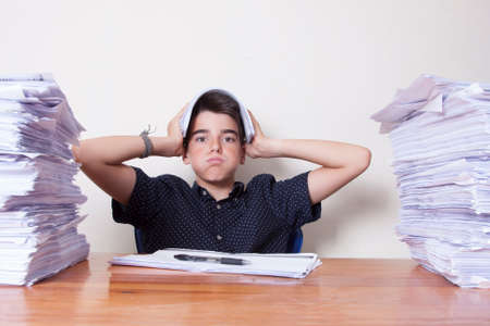 child student on the desk with stacked papers