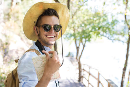 young travel and exploration with the camera and mapの写真素材