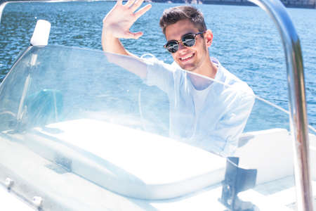 young man sailing on the yachtの写真素材