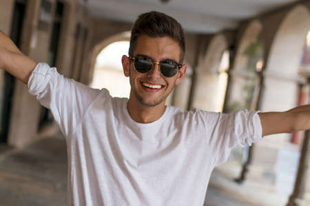 smiling young man in the street of the cityの写真素材