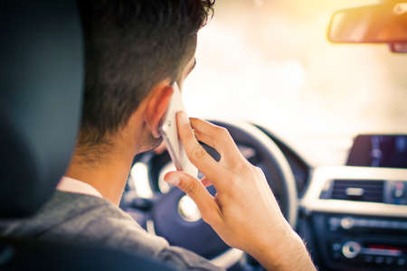 A man on car talking to the mobile phone