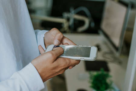 Closeup of a man's hands with mobile phoneの写真素材