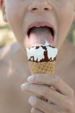 closeup of the mouth with the ice creamの写真素材