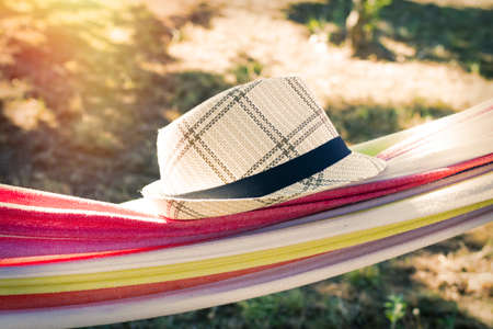 hammock with hat at sunset summer, holiday conceptの写真素材