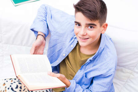 young studying with the book open in the house roomの写真素材