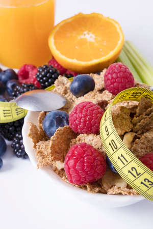 fruits with cereals and tape measure, diet conceptの写真素材