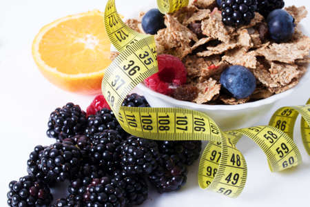 fruits with cereals and tape measure, diet conceptの写真素材
