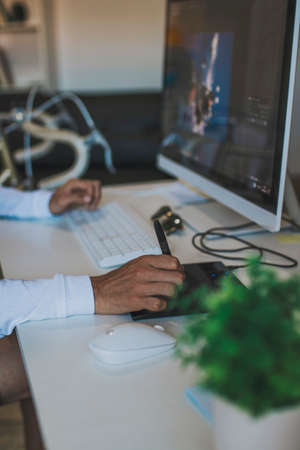 hand on the digital tablet on the desktopの写真素材