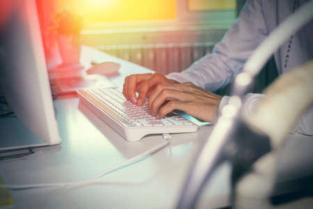 hands on the computer keyboard on the desktop