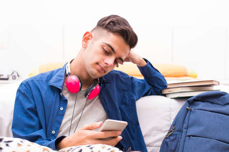 young at home with mobile phone and earphones