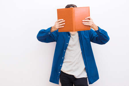 young teenager to fashion reading the book supported on the wallの写真素材