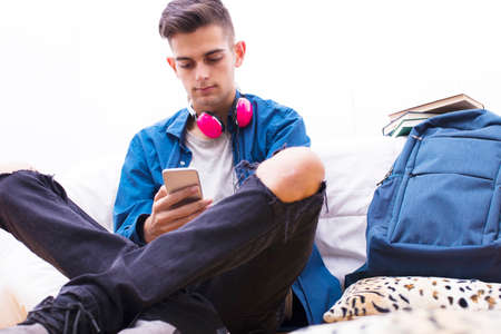 young with mobile phone listening to musicの写真素材