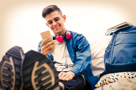 young with mobile phone listening to musicの写真素材