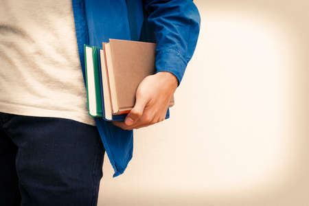 closeup of the student's hands with the booksの写真素材
