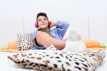 young teenager at home listening to music in the room