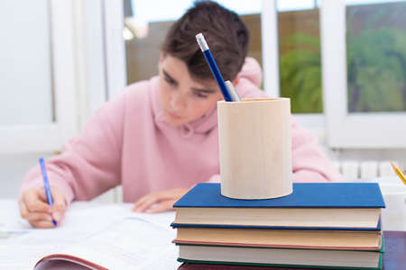 adolescent student on the desk studying and writingの写真素材