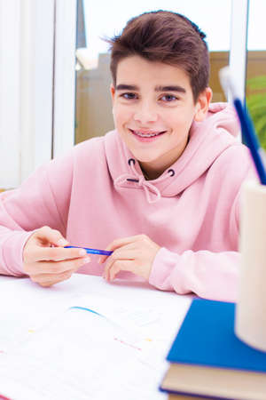 adolescent student on the desk studying and writingの写真素材