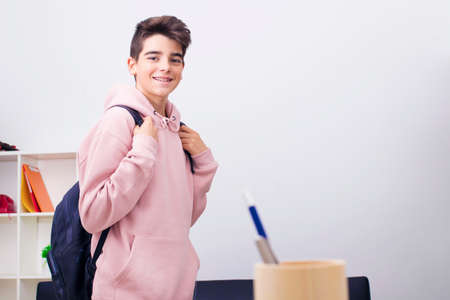 teenage student with school backpack smilingの写真素材