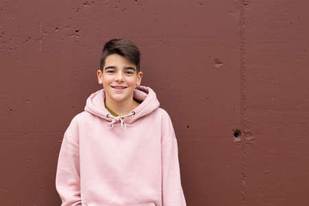 portrait of young preteen on the wall of the street in the cityの写真素材