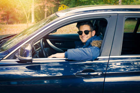 driver smiling inside the carの写真素材