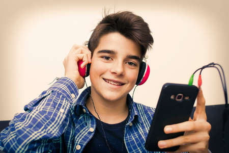 child, teenager or preteen with mobile phone and earphones