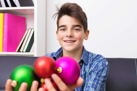 child, teenager or preteen with christmas balls, holiday decorationsの写真素材