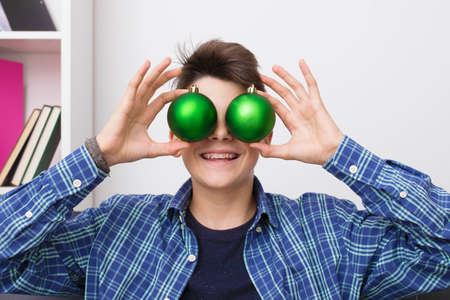 child, teenager or preteen with christmas balls, holiday decorations