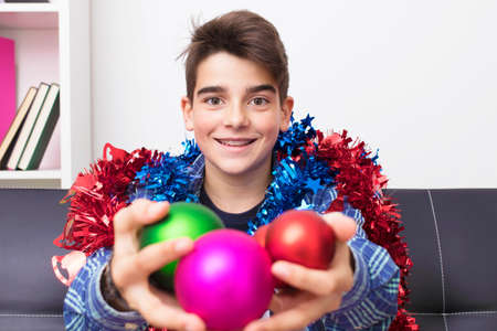 child, teenager or preteen with christmas balls, holiday decorationsの写真素材