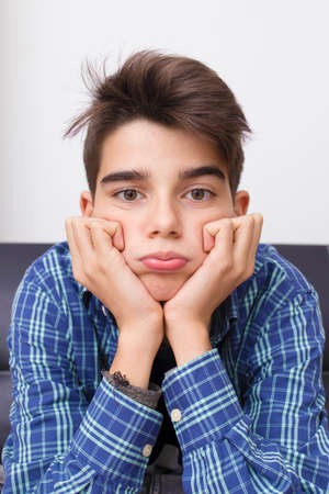 child, teenager or preteen with an expression of boredom or tirednessの写真素材