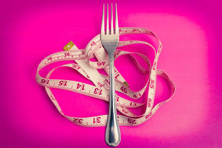 covered with tape measure, diet and slimming conceptの写真素材