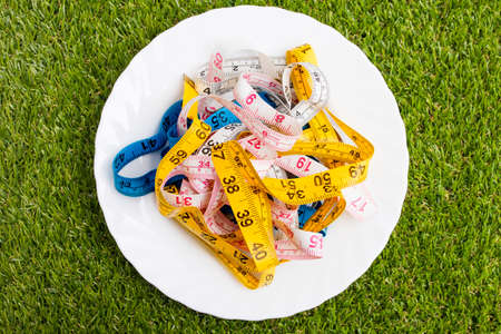 plate with measuring tapes, concept of diet and slimmingの写真素材