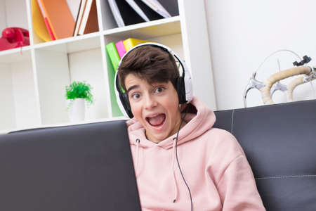 child or teenager with the computer celebrating success