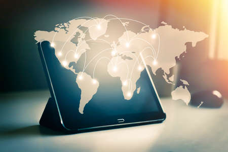 Tablet with map of connections and networksの写真素材