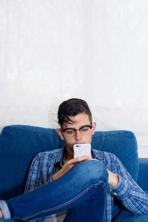 young casual in the home sofa with mobile phone