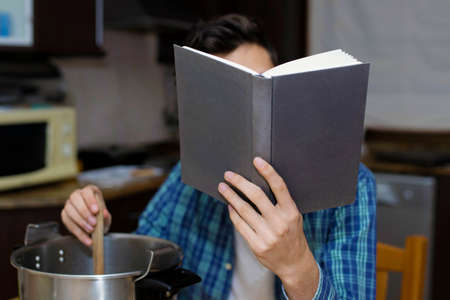 learning to cook with cookbook and pots