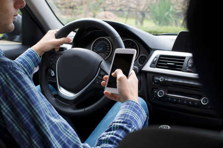driver with mobile phone in car