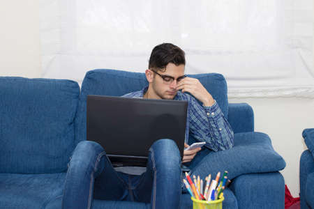 young adult working or studying with the computer at homeの写真素材