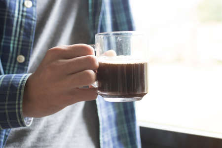 drinking coffee at the window, beverages and conceptの写真素材